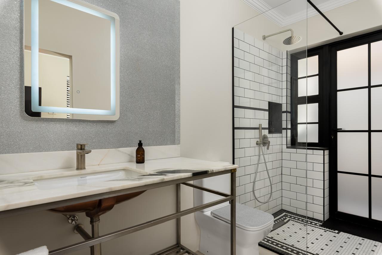 Monochrome bathroom with a frameless walk-in shower