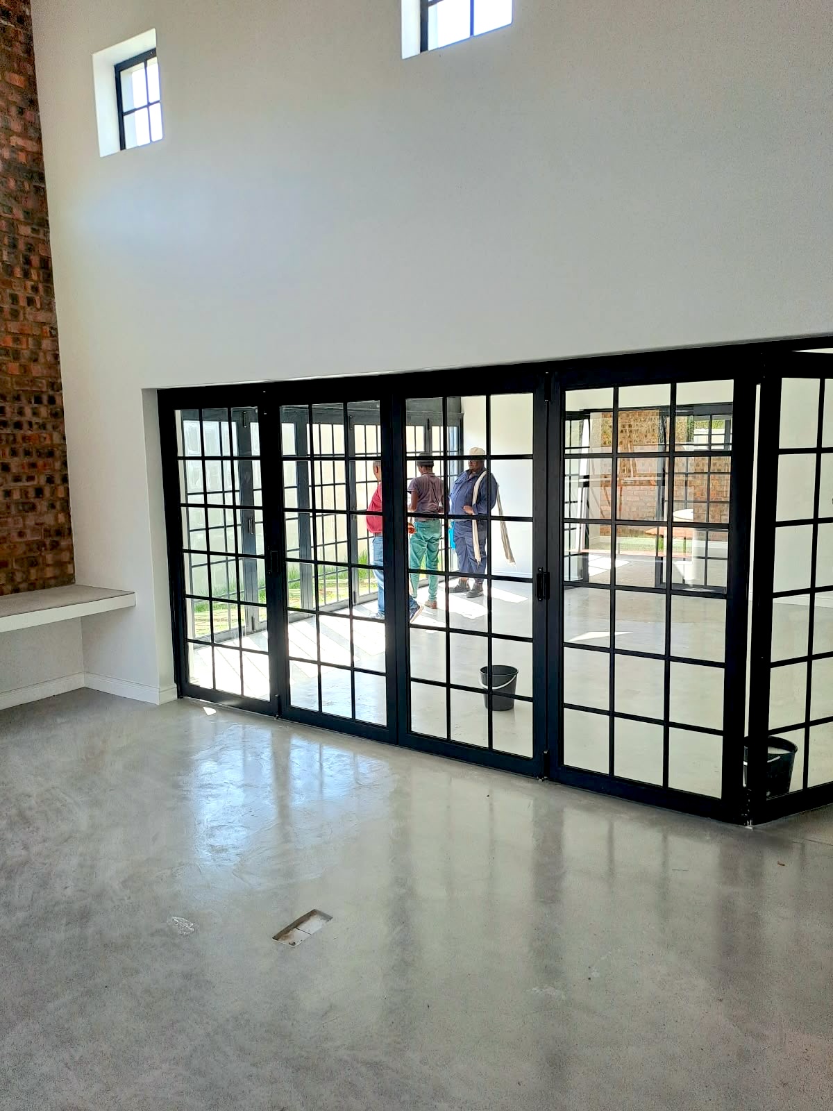 Double-height interior with custom black steel doors