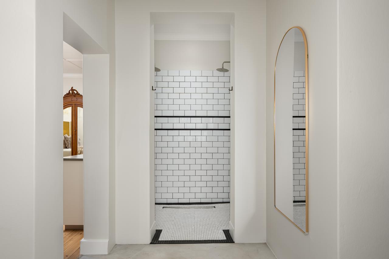 Walk-in shower finished with monochrome subway tiles
